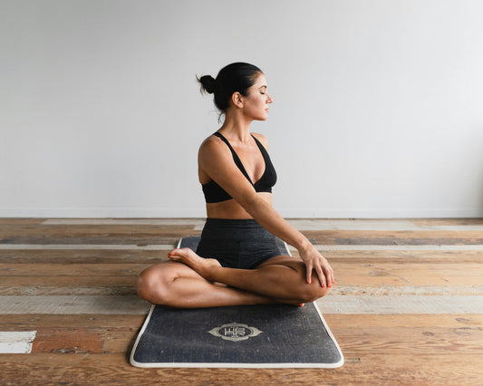 A woman on a mat doing a pilates pose