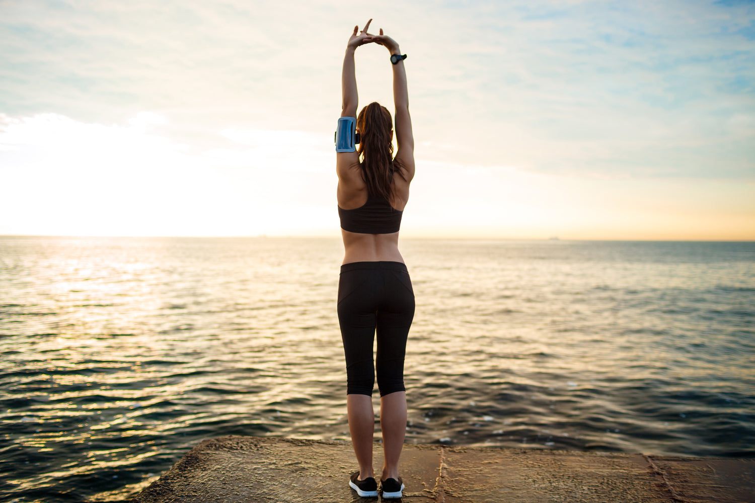 woman stretching out to sea