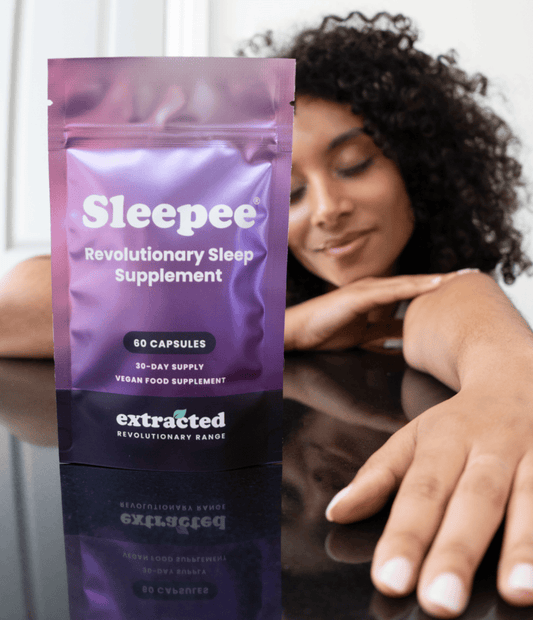 A pouch of Sleepee supplements with a woman in the background