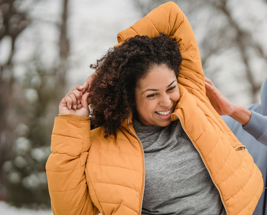 Woman stretching for joint pain in winter