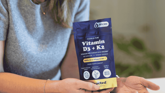Woman holding vitamin D pouch