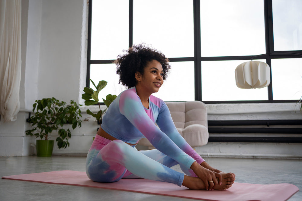 A woman stretching on a mat 