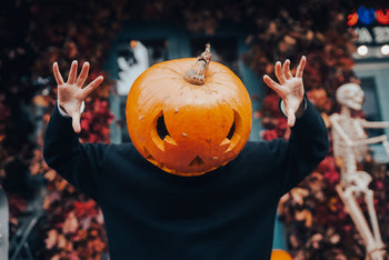 a person with a pumpkin on their head