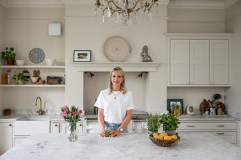 Rachel at her kitchen table with a smoothie