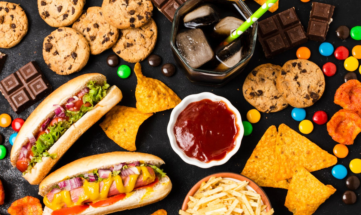 A table full of processed foods like cookies and hot dogs
